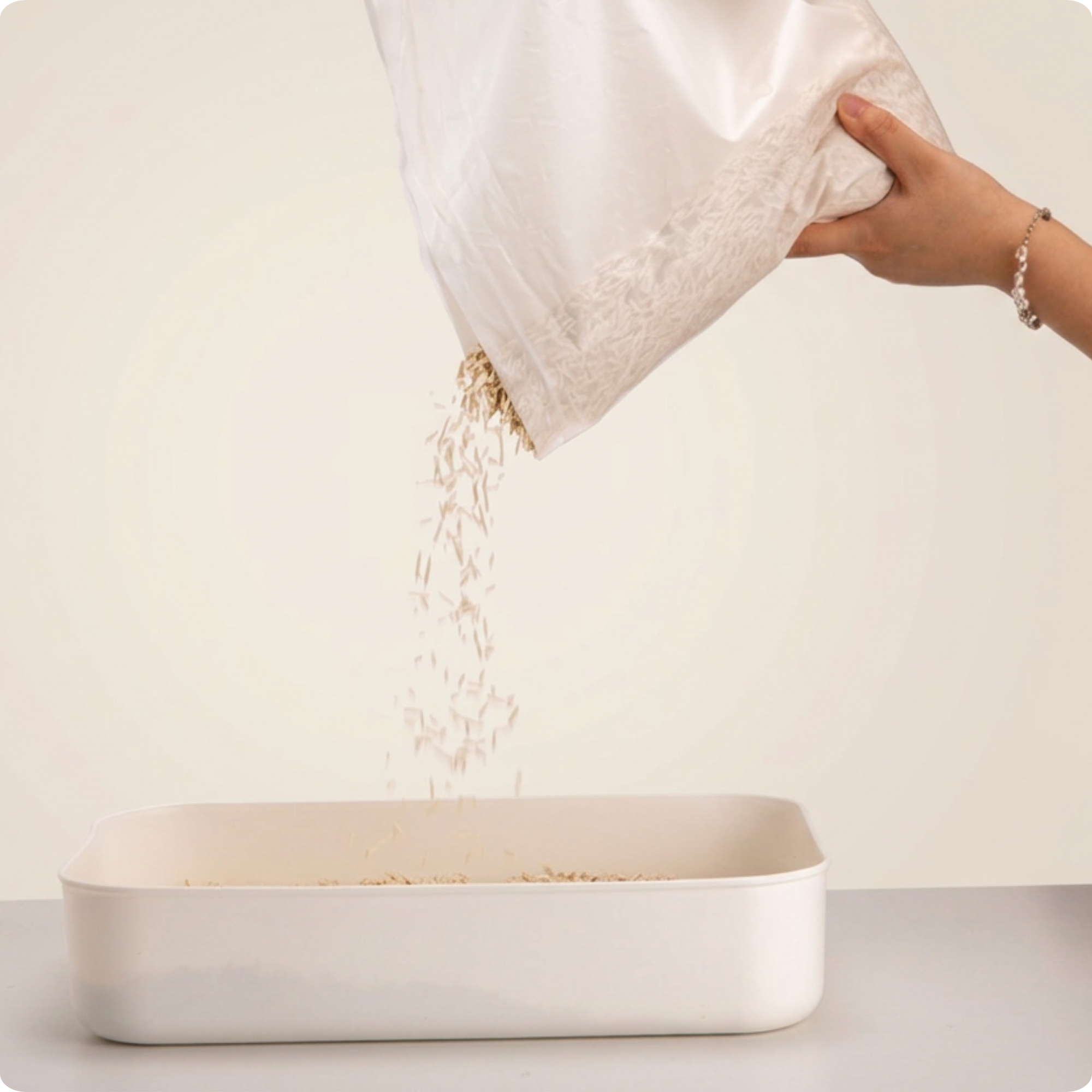 Bestami tofu cat litter being poured from a sealed bag into a litter tray, showing proper storage before use